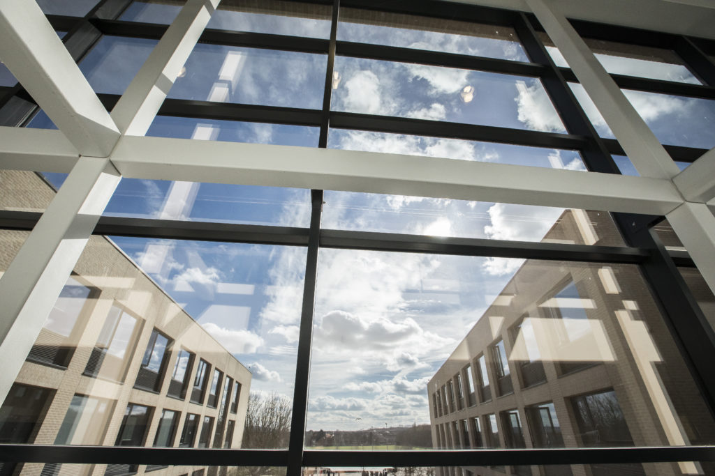 A shot of the large windows in the academy building which look out onto a patio area on the grounds.